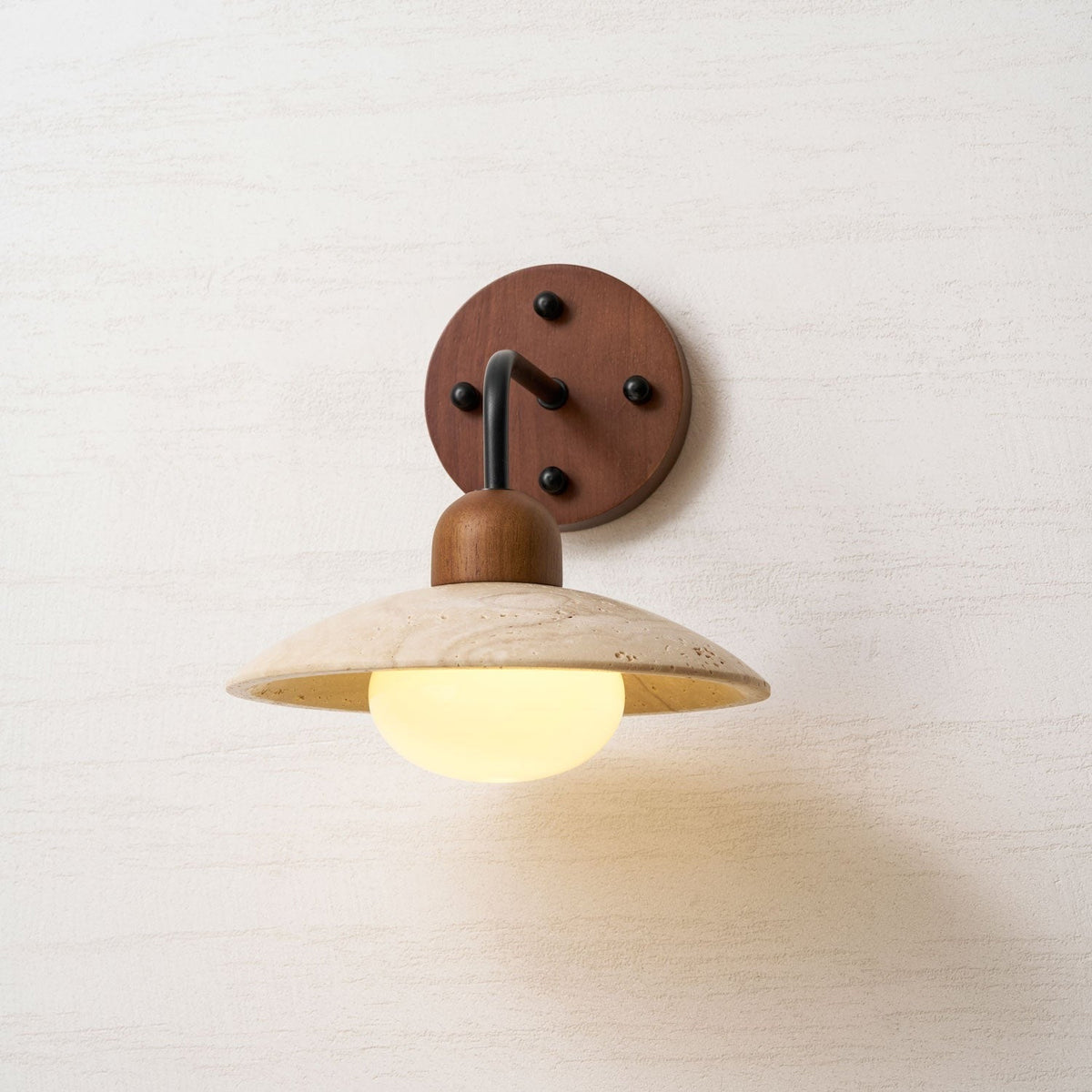 Glamour shot of yellow travertine dome on Boticas wall sconce