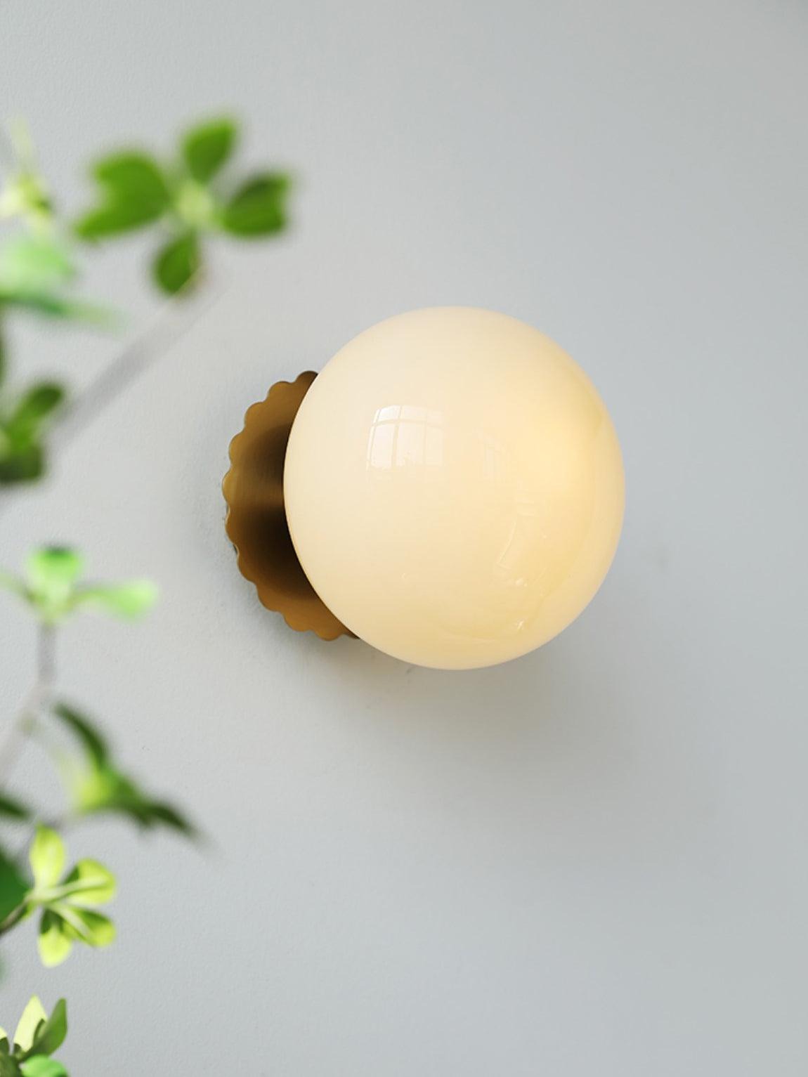 Marshmallow sconce gold finish with pink glass detail shot