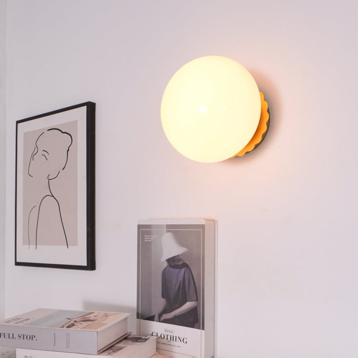 Marshmallow sconce in hallway providing accent lighting above console