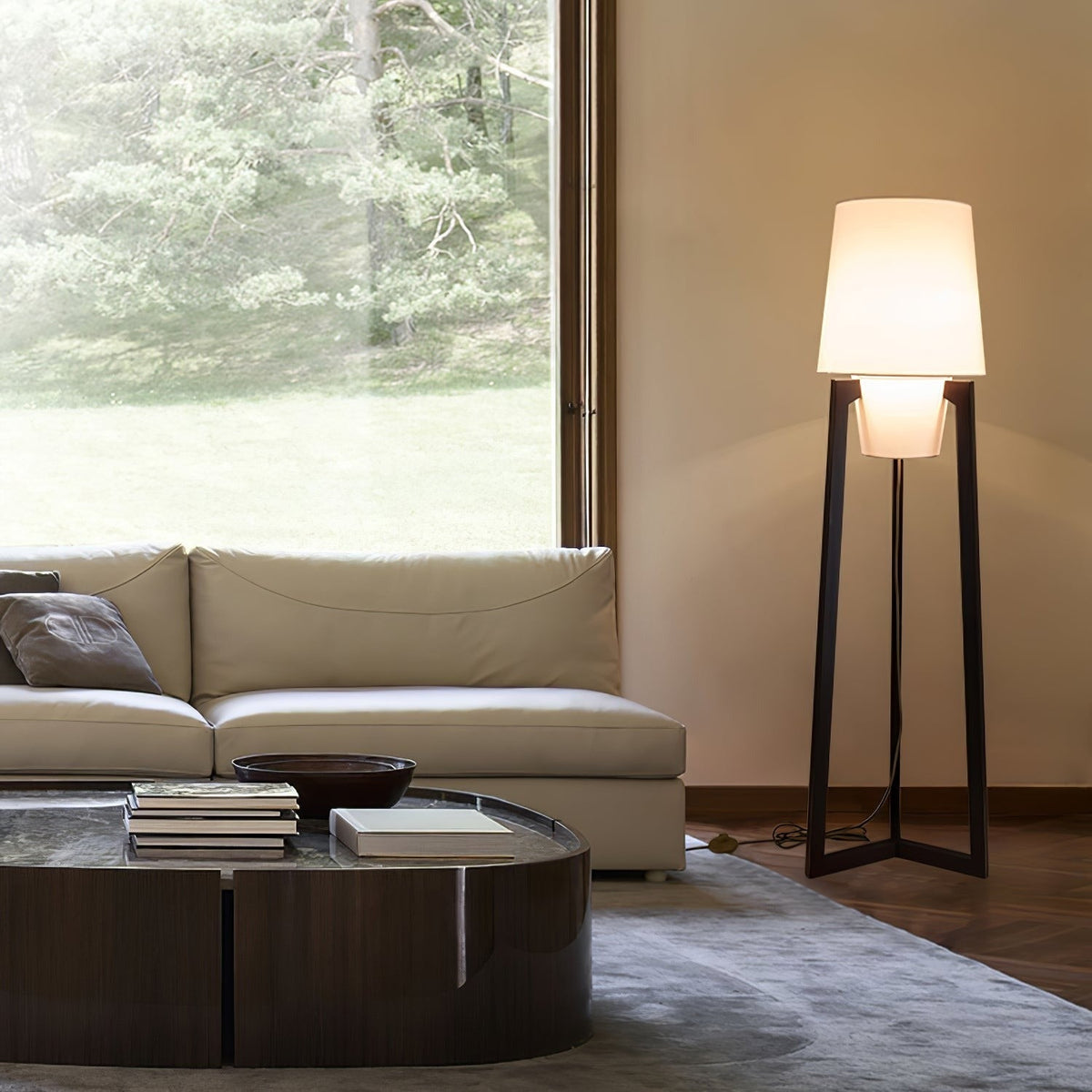 Morros floor lamp lit beside a cream sofa by a window
