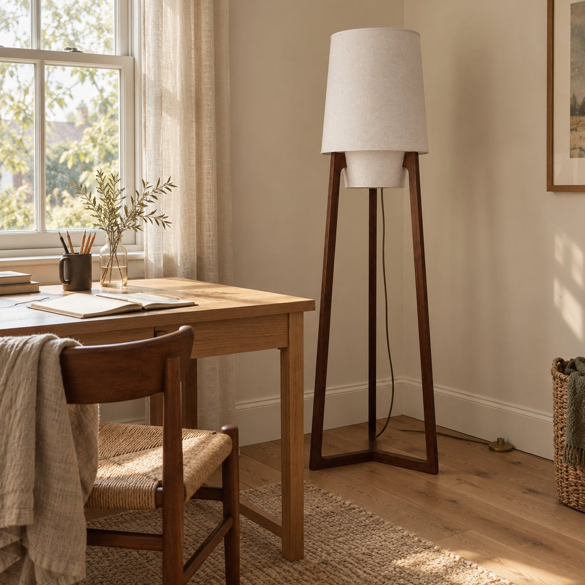 Morros tripod linen floor lamp in brown walnut, 165 cm, beside an oak desk in a spare room.
