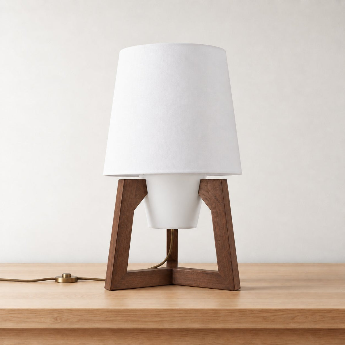 Morros small tripod linen table lamp in brown walnut, 40 x 70 cm (15.7 x 27.6 in), on an oak tabletop.