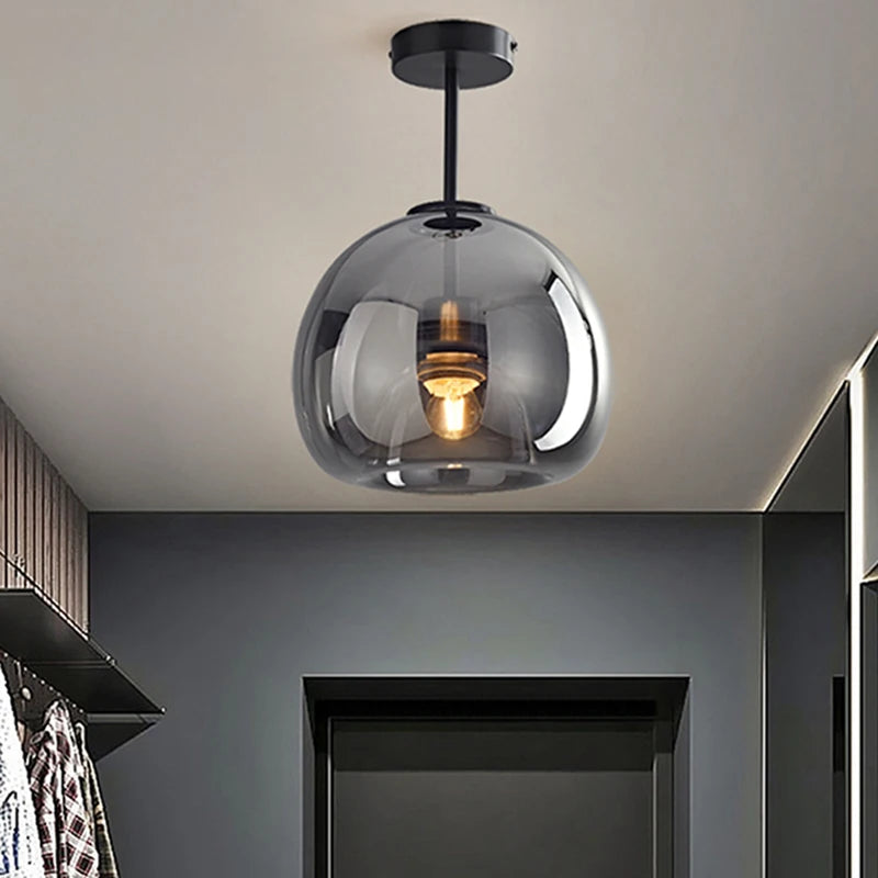 Oren smoke glass semi-flush ceiling light with a black canopy illuminating a modern hallway