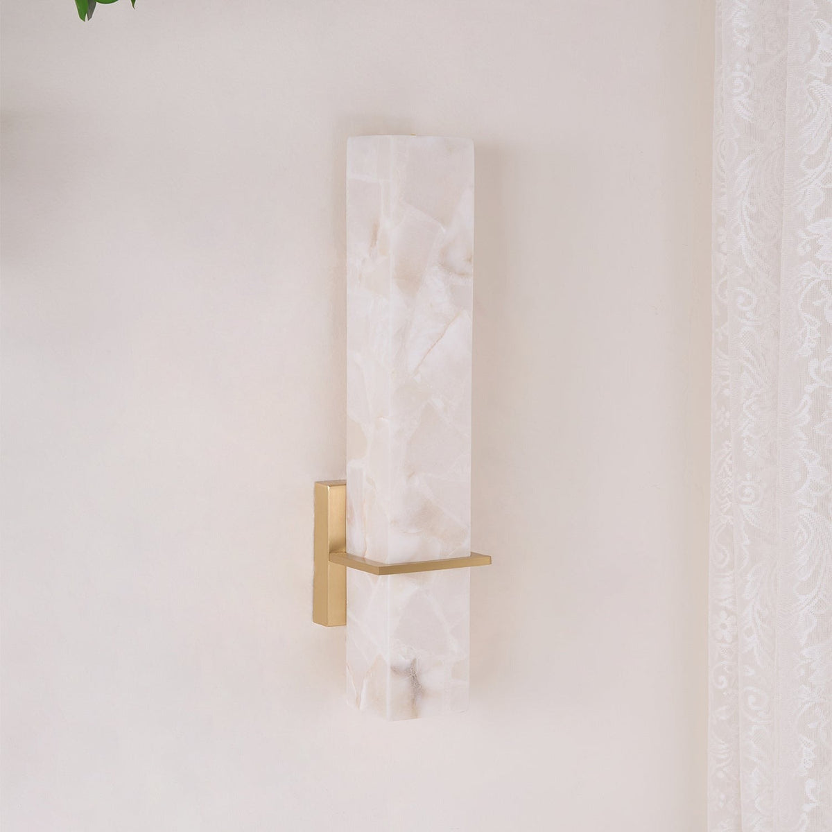 Sconce shadow detail on wall surface below mounting