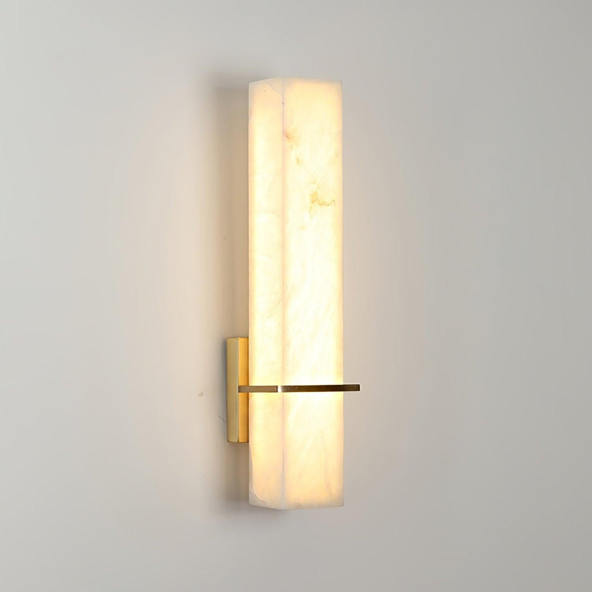 Shadows cast by vertical bar sconce on wall