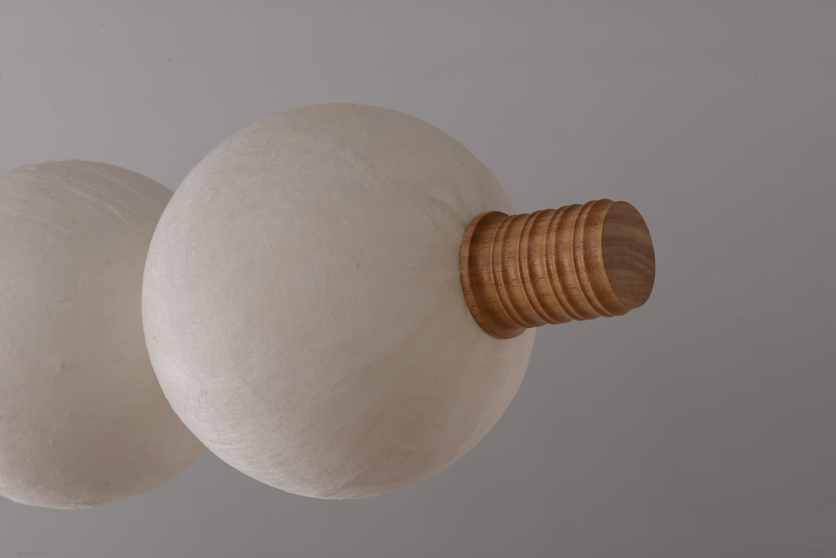 Real close-up of unlit natural mulberry silk shade and light wood ridged endcap