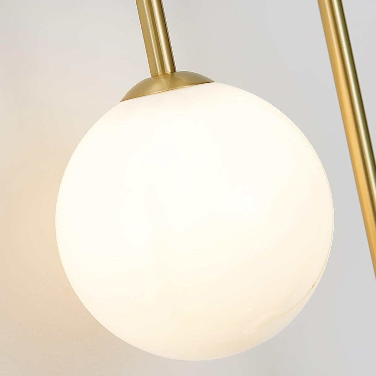 Studio profile view of Alcoutim curved brass sconce