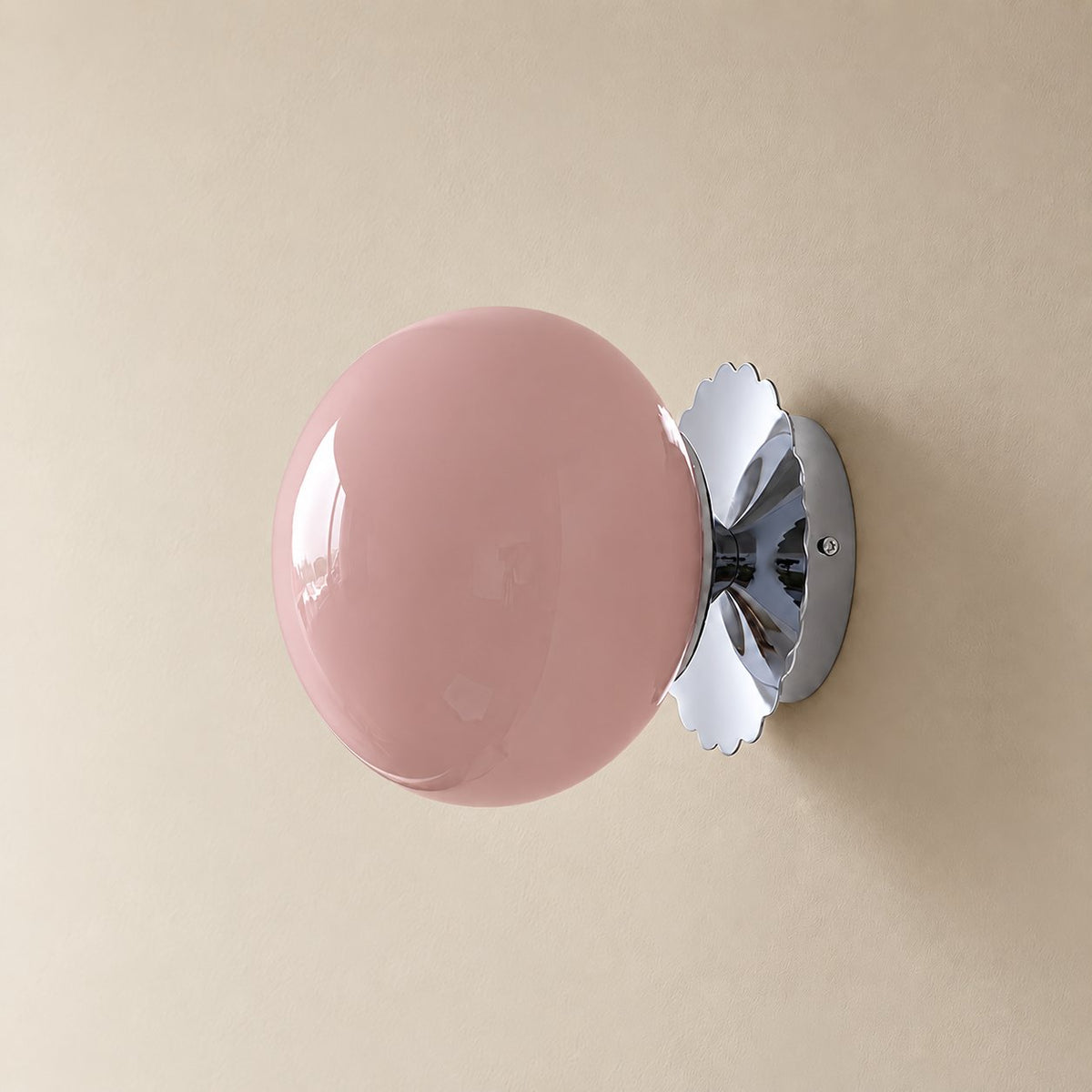 Tâmega convertible wall sconce in polished chrome with pink tinted glass, unlit on a plain plaster wall.