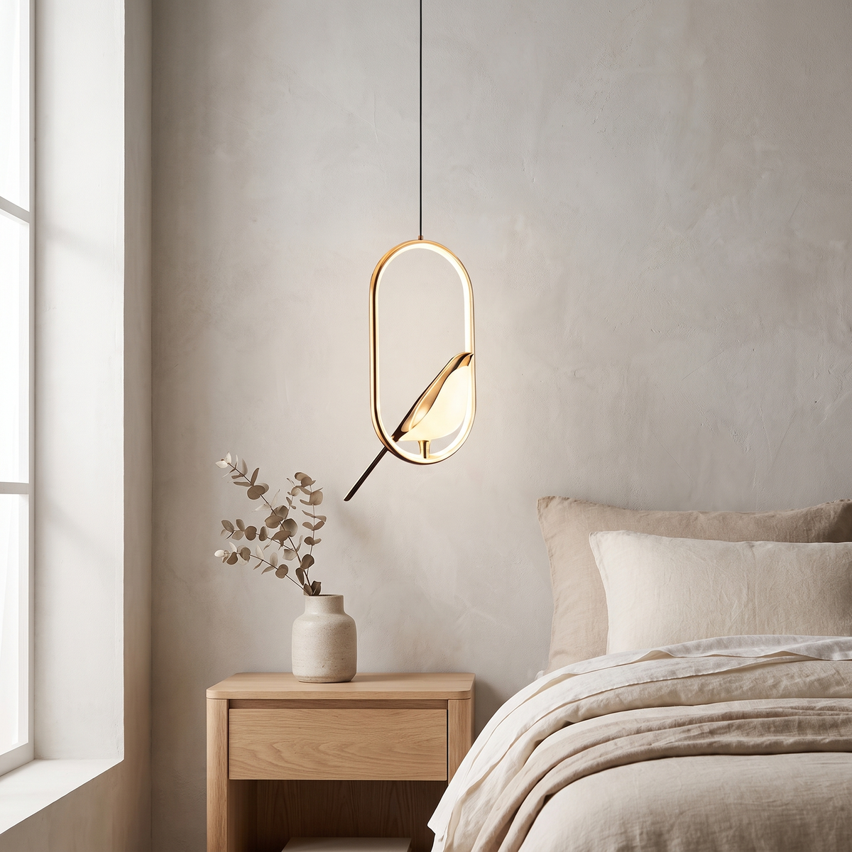 Tind bird pendant light with a gold oval frame hanging above an oak nightstand beside a linen bed