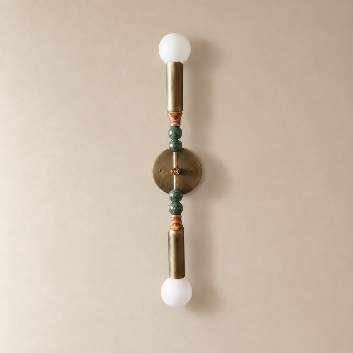 Torto marble wall sconce in antique brass and green marble, Tall (70 cm), unlit on a plain plaster wall.
