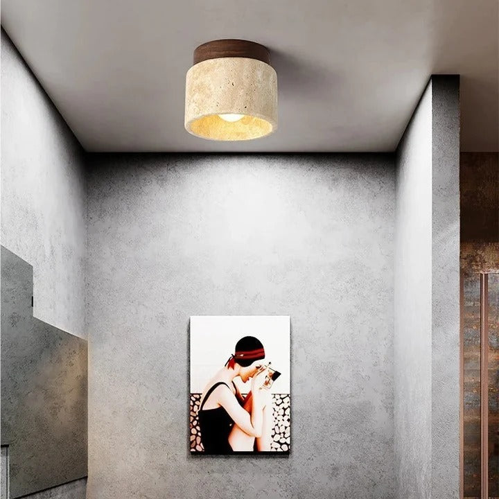 Tova travertine ceiling light mounted in a minimalist gray interior