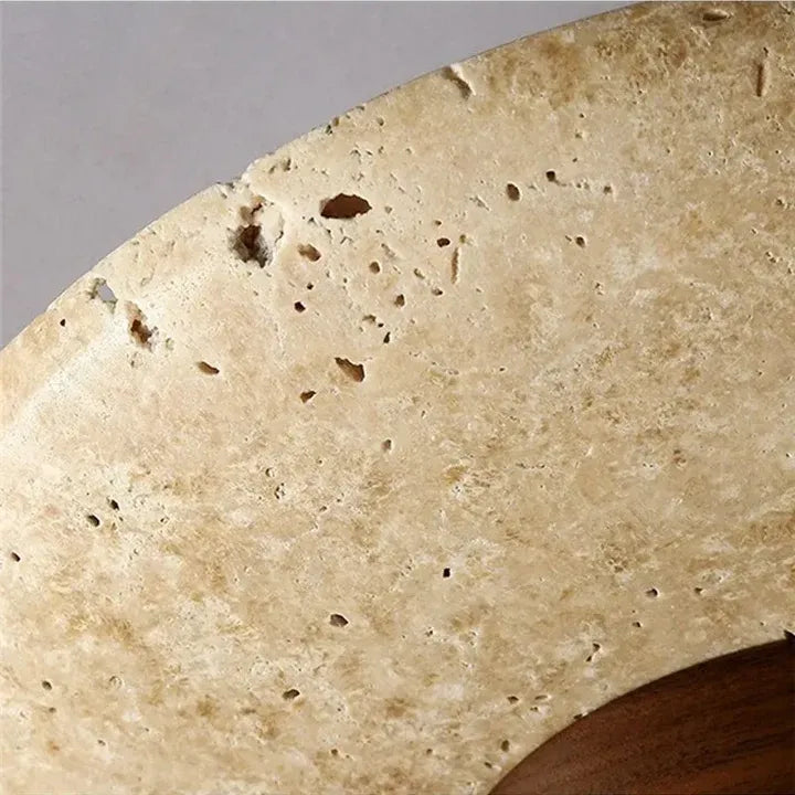 Detailed view of the Tova ceiling light's beige travertine texture