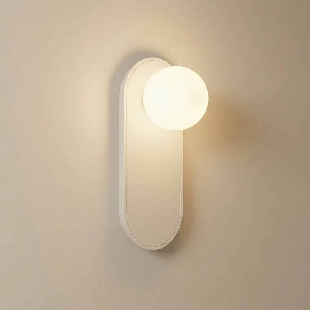 Valença wall sconce front view, white pill-shaped metal backplate with opal white glass globe near the top