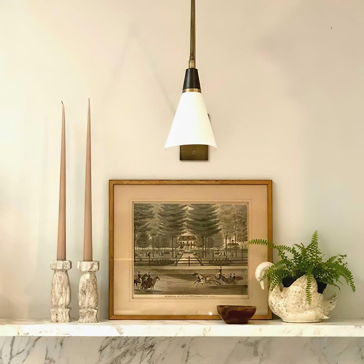 White fabric shade and brass accent details on wall light